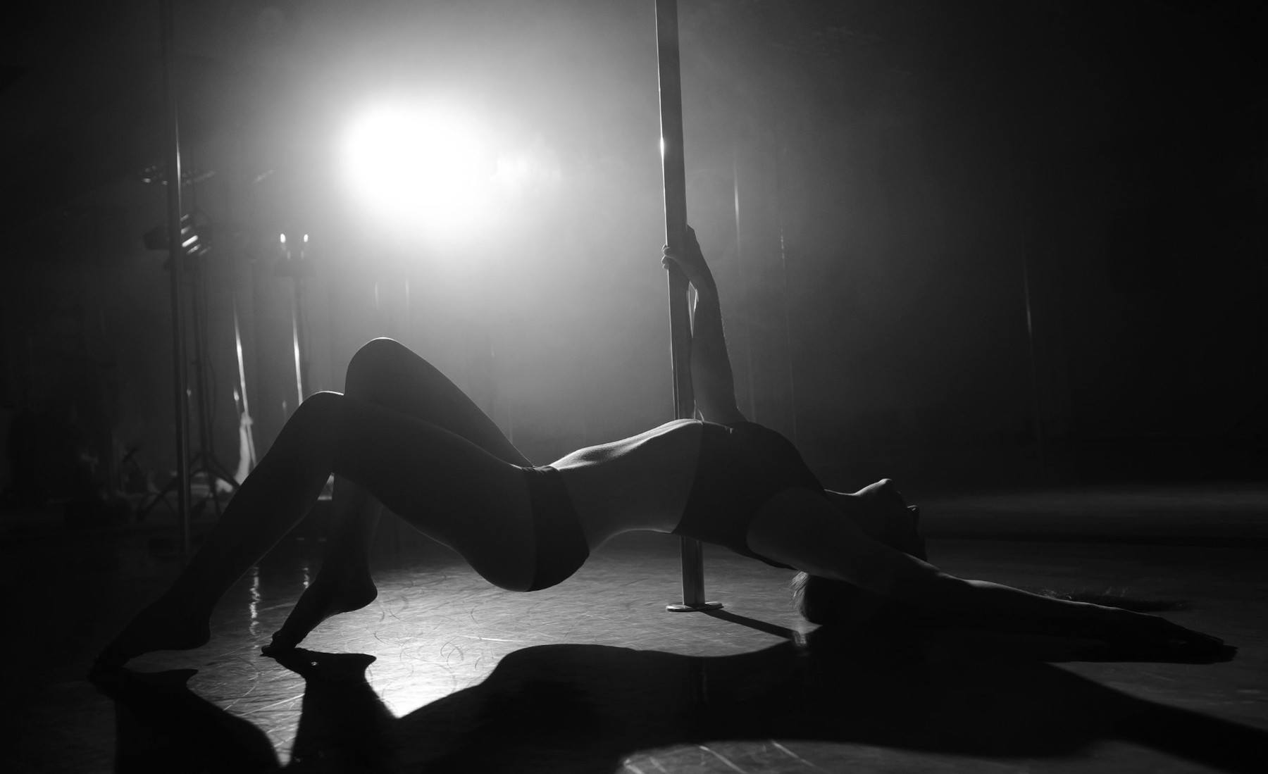 a person sitting on a bed in a dark room